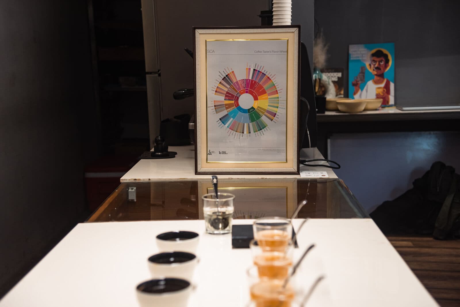 Cupping table with the SCA Coffee Taster's Flavor Wheel