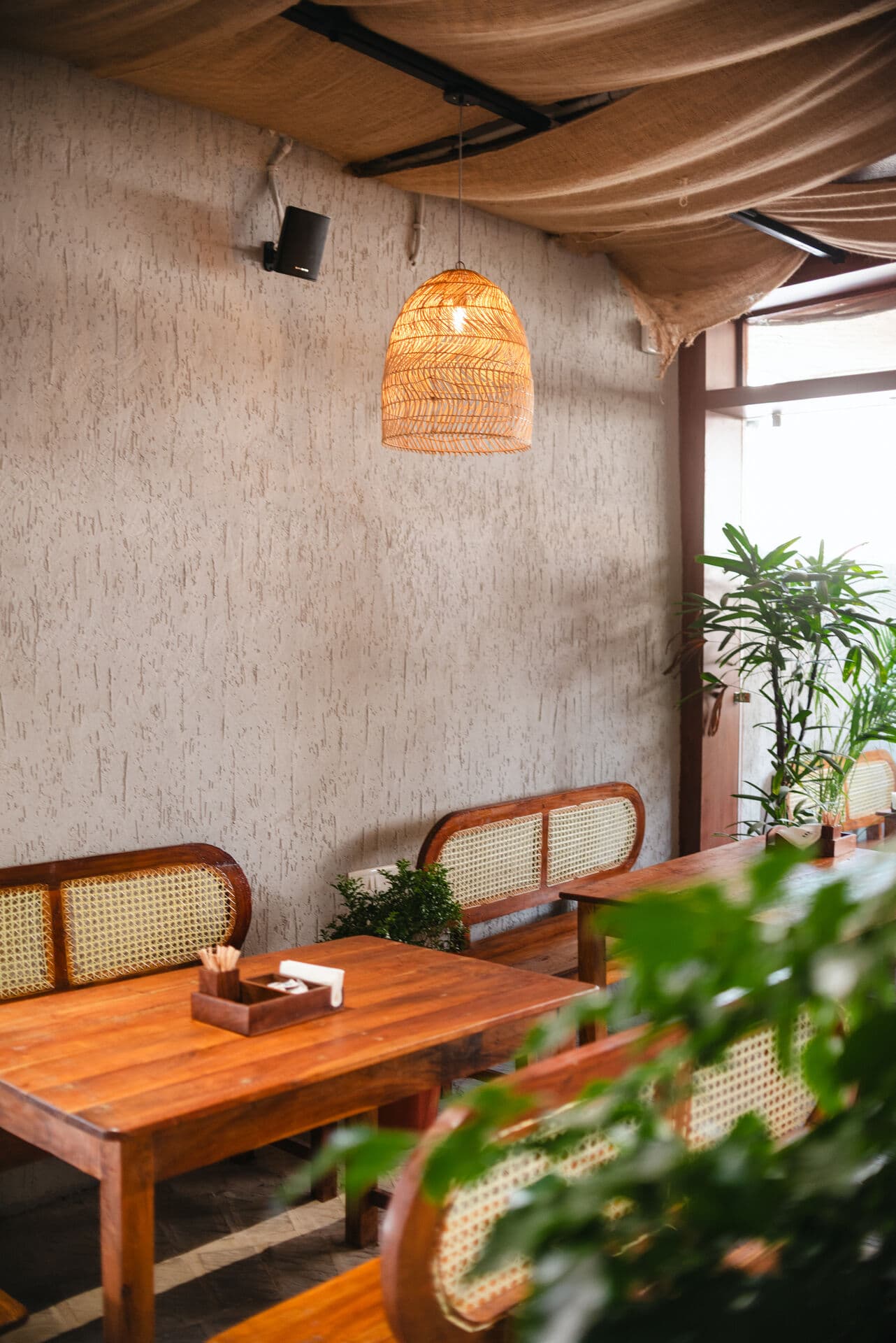Inside a 1DM cafe — warm lighting and cane seating